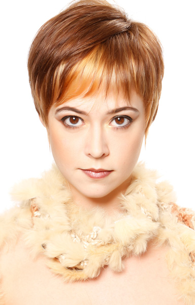 Classic pixie haircut with creative bicolor strawberry to light auburn hair color.