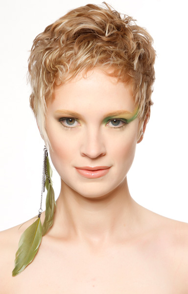 Multi dimensional blonde hair color with wavy short pixie haircut.